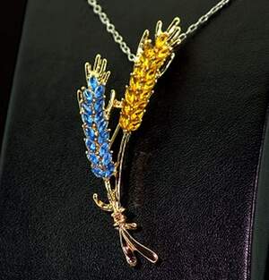 Брошка в позолоте з жовто-голубыми фианитами