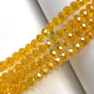 Бусины хрустальные рондель 8х6мм, нить-65 шт, желтый прозрачный с покрытием АВ Бусины хрустальные рондель 8х6мм, нить-65 шт, желтый прозрачный с покрытием АВ