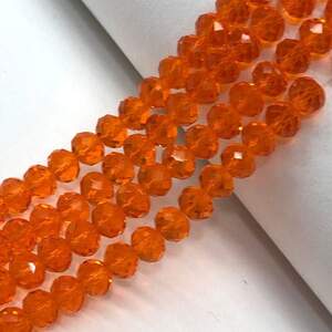 Бусины хрустальные рондель 8х6мм, нить-65 шт, оранжевый прозрачный Бусины хрустальные рондель 8х6мм, нить-65 шт, оранжевый прозрачный
