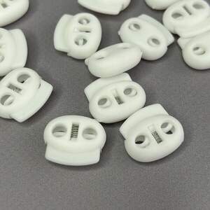 Фиксатор для шнура пластиковый 19 мм, белый